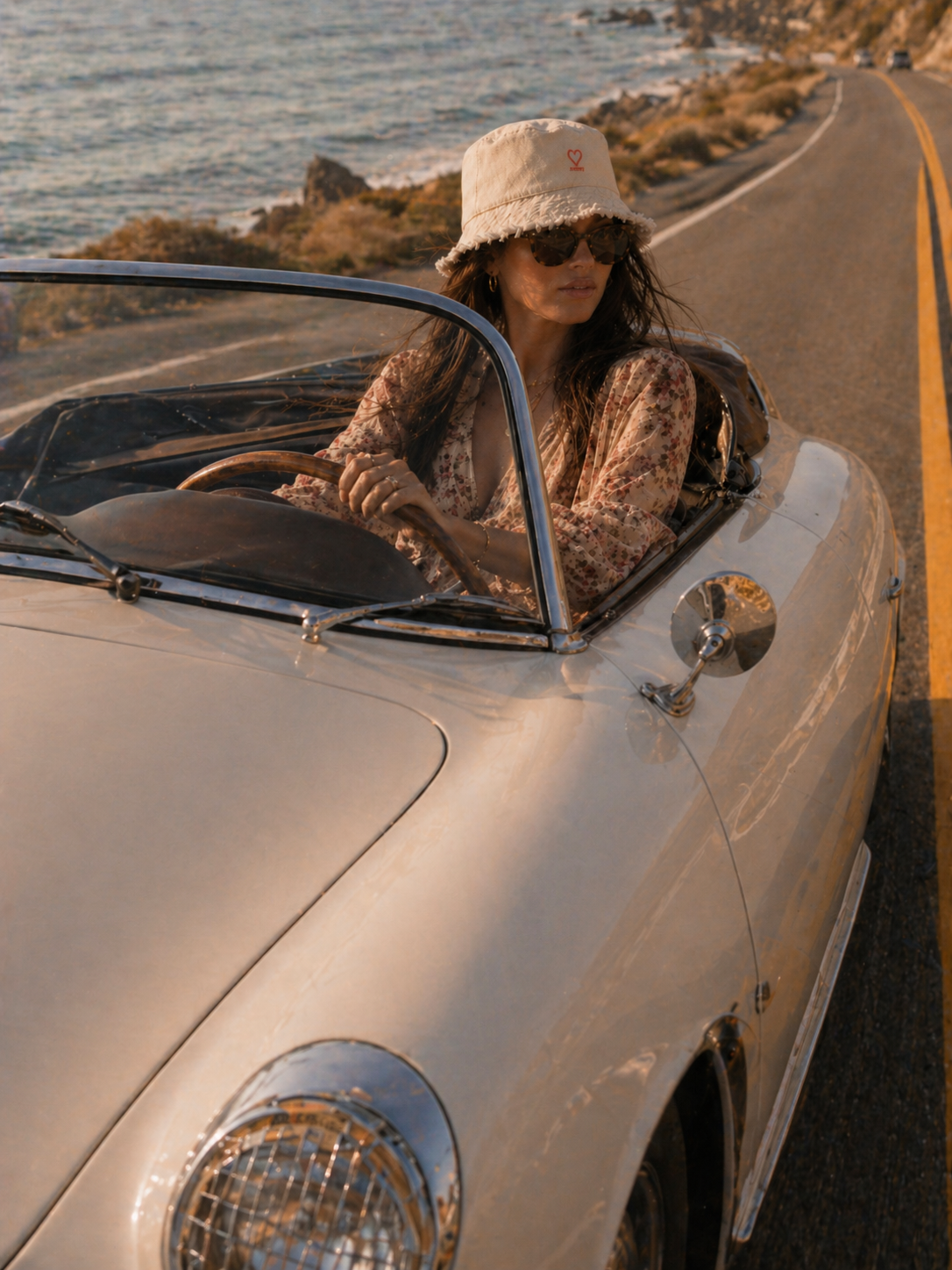 Model wearing cream denim frayed edge bucket hat in a car