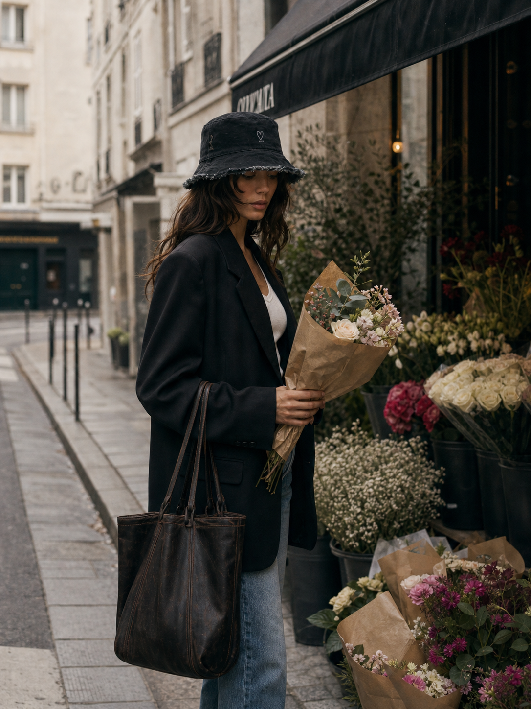 Model wearing black denim frayed edge bucket hat