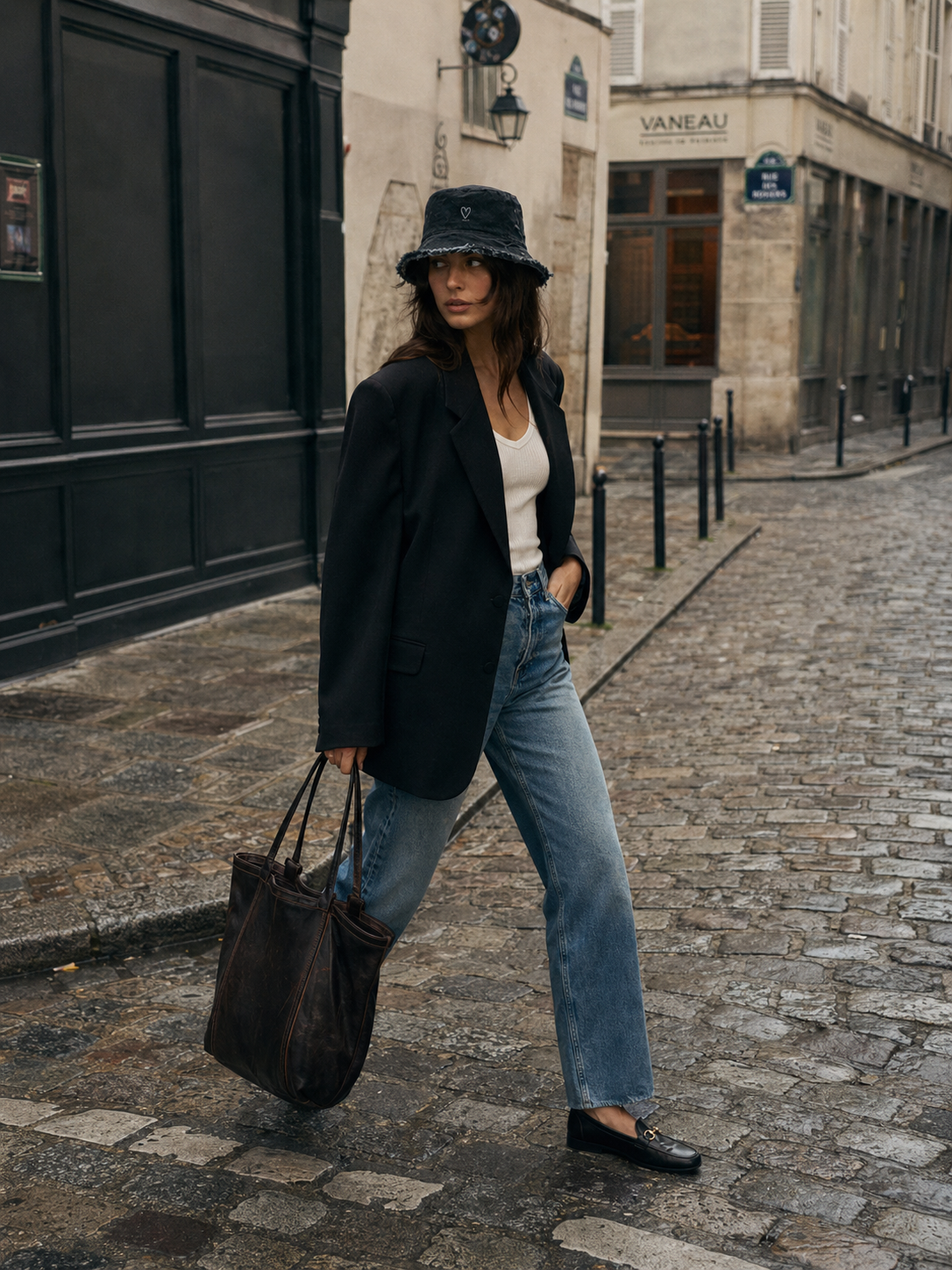 Model wearing black denim frayed edge bucket hat